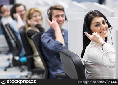 group of young business people with headset working and giving support to customers in a call center office