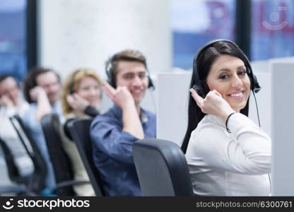 group of young business people with headset working and giving support to customers in a call center office