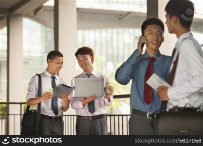 Group of young businessmen working and discussing outdoor