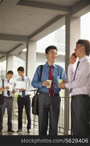 Group of young businessmen working and discussing outdoor
