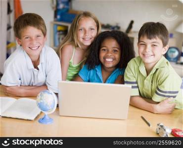 Group Of Young Children Doing Their Homework On A Laptop