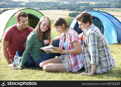 Group Of Young Friends Camping In Countryside Reading Map