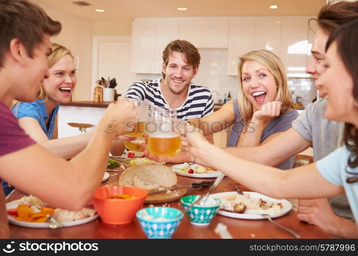 Group Of Young Friends Enjoying Meal At Home