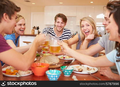 Group Of Young Friends Enjoying Meal At Home