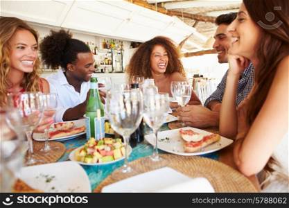 Group Of Young Friends Enjoying Meal In Outdoor Restaurant