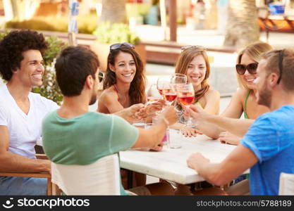 Group Of Young Friends Enjoying Meal In Outdoor Restaurant