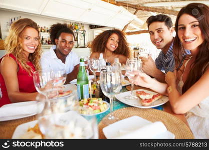 Group Of Young Friends Enjoying Meal In Outdoor Restaurant