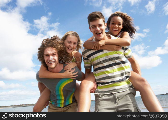 Group Of Young Friends Having Fun On Summer Beach Together