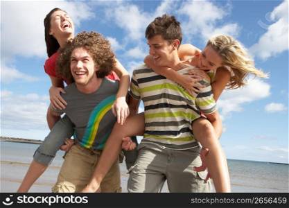 Group Of Young Friends Having Fun On Summer Beach Together