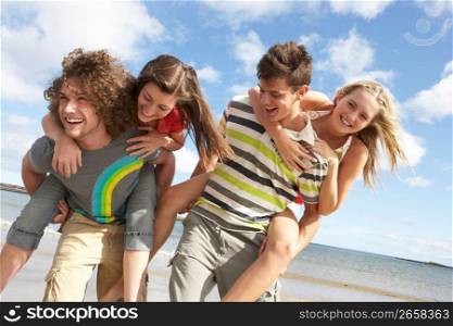 Group Of Young Friends Having Fun On Summer Beach Together