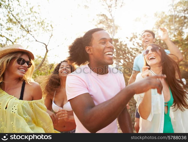 Group Of Young Friends Having Party On Beach Together