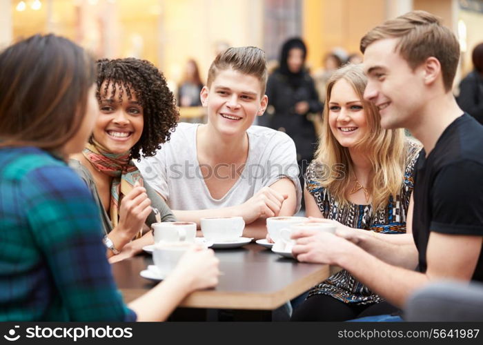 Group Of Young Friends Meeting In Cafe