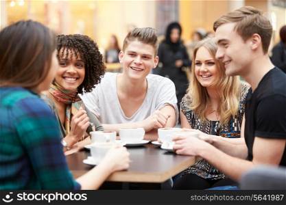 Group Of Young Friends Meeting In Cafe