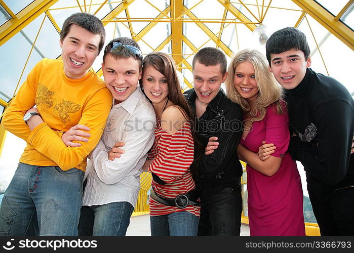 group of young friends on footbridge look on you