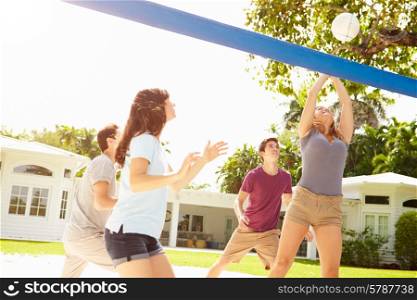 Group Of Young Friends Playing Volleyball Match