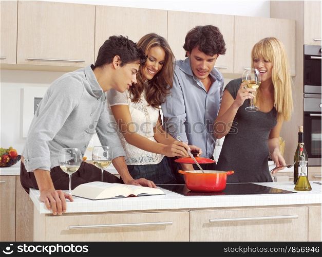 Group Of Young Friends Preparing Breakfast In Modern Kitchen