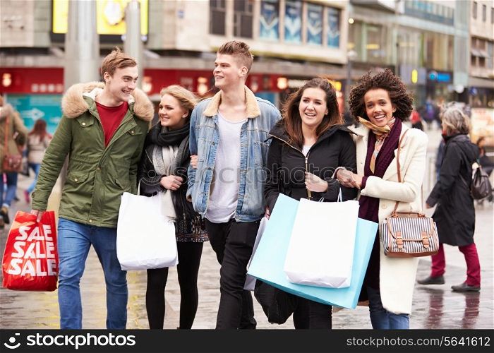 Group Of Young Friends Shopping Outdoors Together