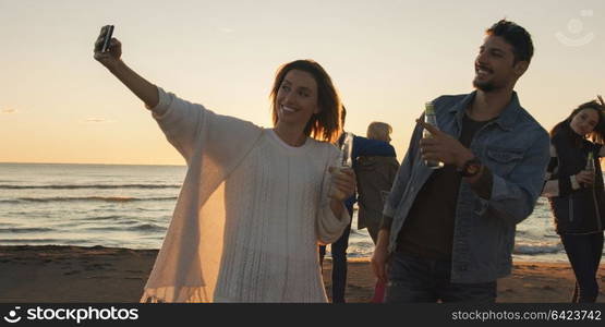 Group Of Young Friends Spending The Day On A Beach during autumn day