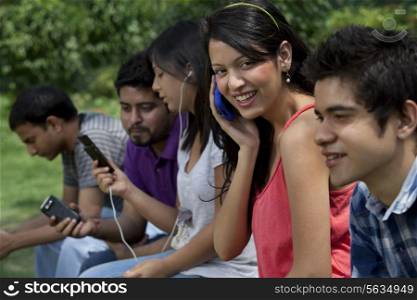 Group of young friends using cell phones