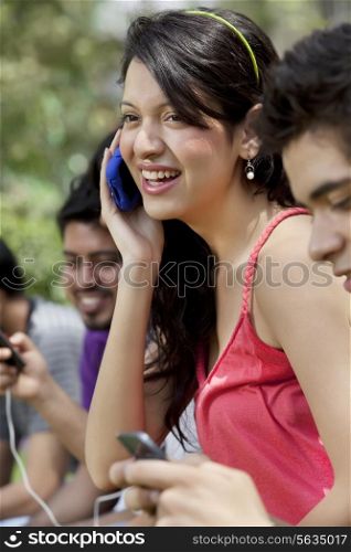 Group of young friends using mobile phone