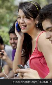 Group of young friends using mobile phone