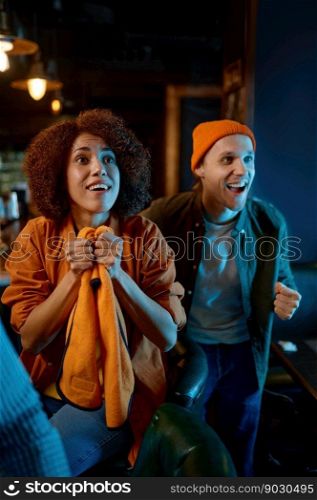 Group of young friends watching TV and support team while resting in pub. Cheerful people waiting for goal. Sport leisure lifestyle concept. Group of young friends watching TV and support team while resting in pub