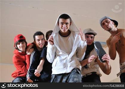 group of young happy boys posing together in dence studio
