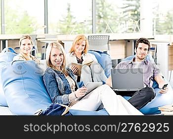 Group of young high-school or university students learning and relaxing