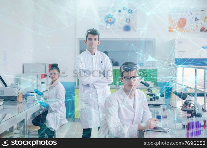 Group of young medical students doing research together in chemistry laboratory,teamwork by college student indoors