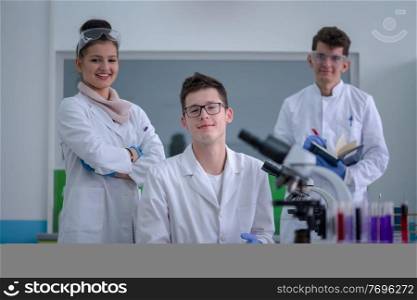 Group of young medical students doing research together in chemistry laboratory,teamwork by college student indoors