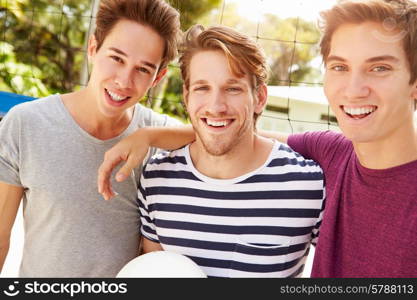 Group Of Young Men Playing Volleyball Match