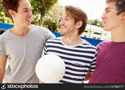 Group Of Young Men Playing Volleyball Match