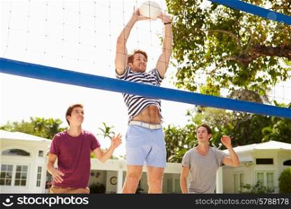 Group Of Young Men Playing Volleyball Match