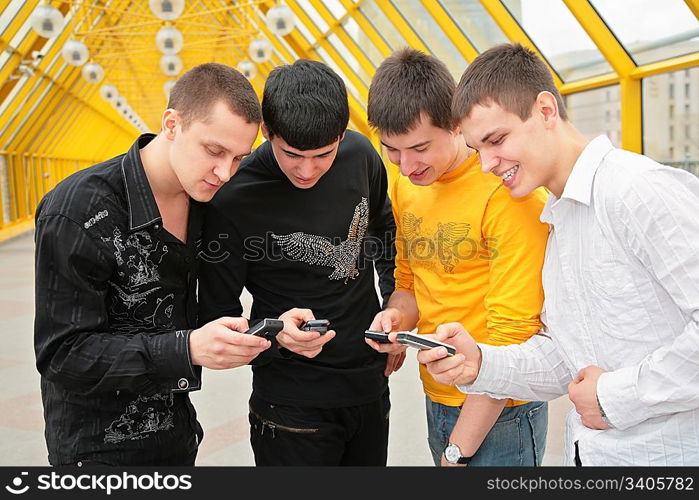 group of young men with cell phones