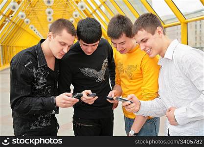 group of young men with cell phones