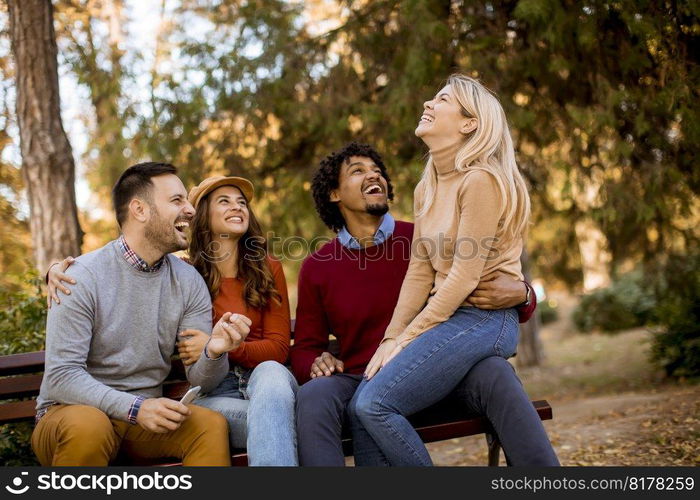 Group of young multiethnic friends having fun at autumn park