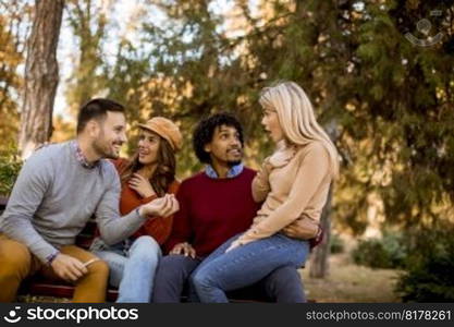 Group of young multiethnic friends having fun at autumn park