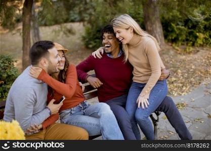 Group of young multiethnic friends having fun at autumn park