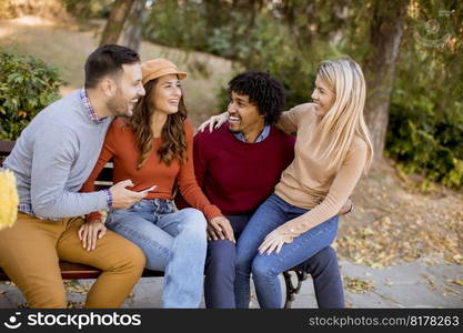 Group of young multiethnic friends having fun at autumn park