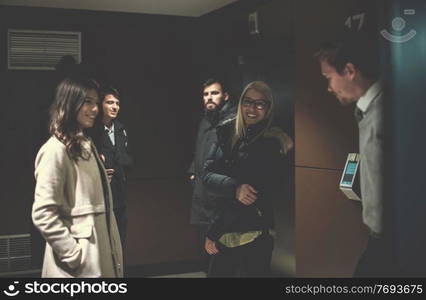 group of young multiethnic startup business team having a coffee break at the hallway in front of office