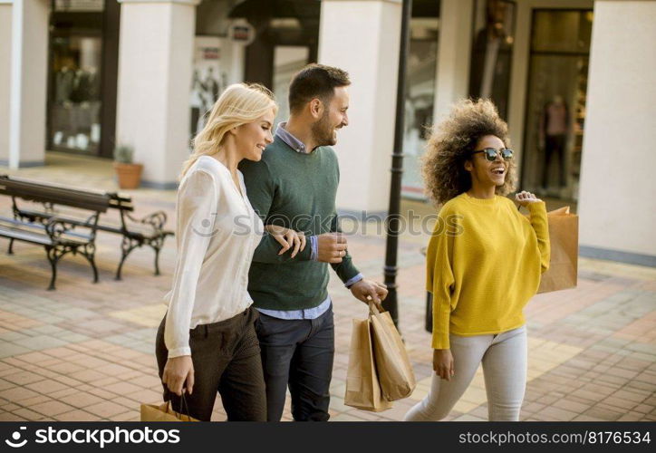 Group of young multiracial friends shopping in mall together