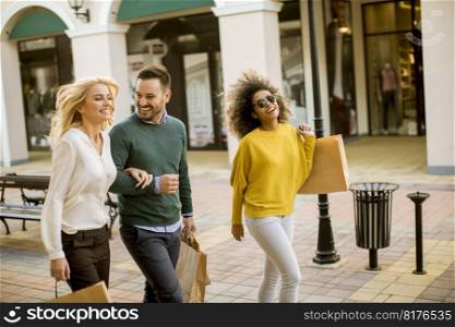 Group of young multiracial friends shopping in mall together