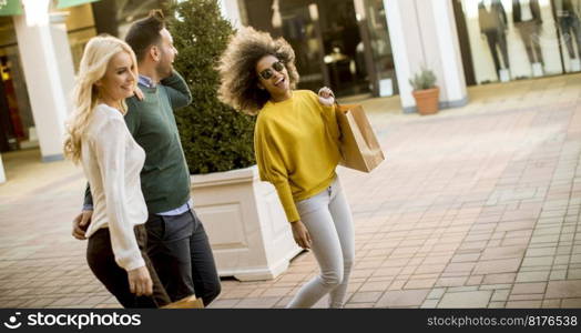 Group of young multiracial friends shopping in mall together