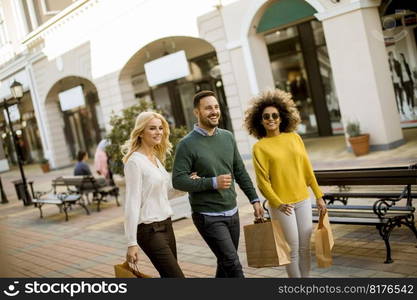 Group of young multiracial friends shopping in mall together