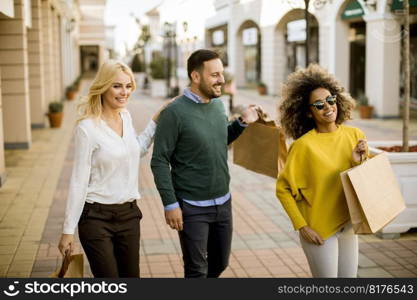 Group of young multiracial friends shopping in mall together