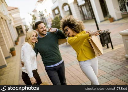 Group of young multiracial friends shopping in mall together