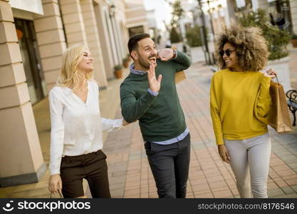 Group of young multiracial friends shopping in mall together