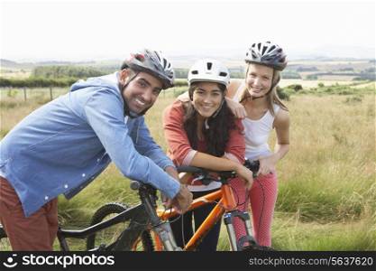 Group Of Young People Cycling In Countryside