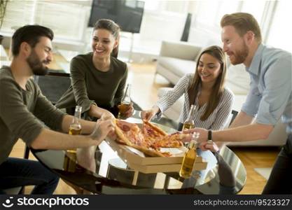 Group of young people eating pizza and drink cider in the room