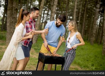 Group of young people enjoying barbecue party in park